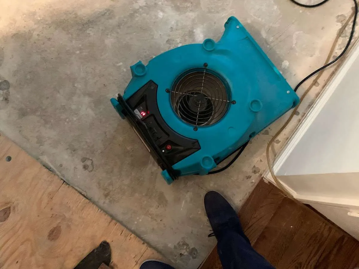 Air mover drying subfloor during Leak Detection & Repair in New Canaan